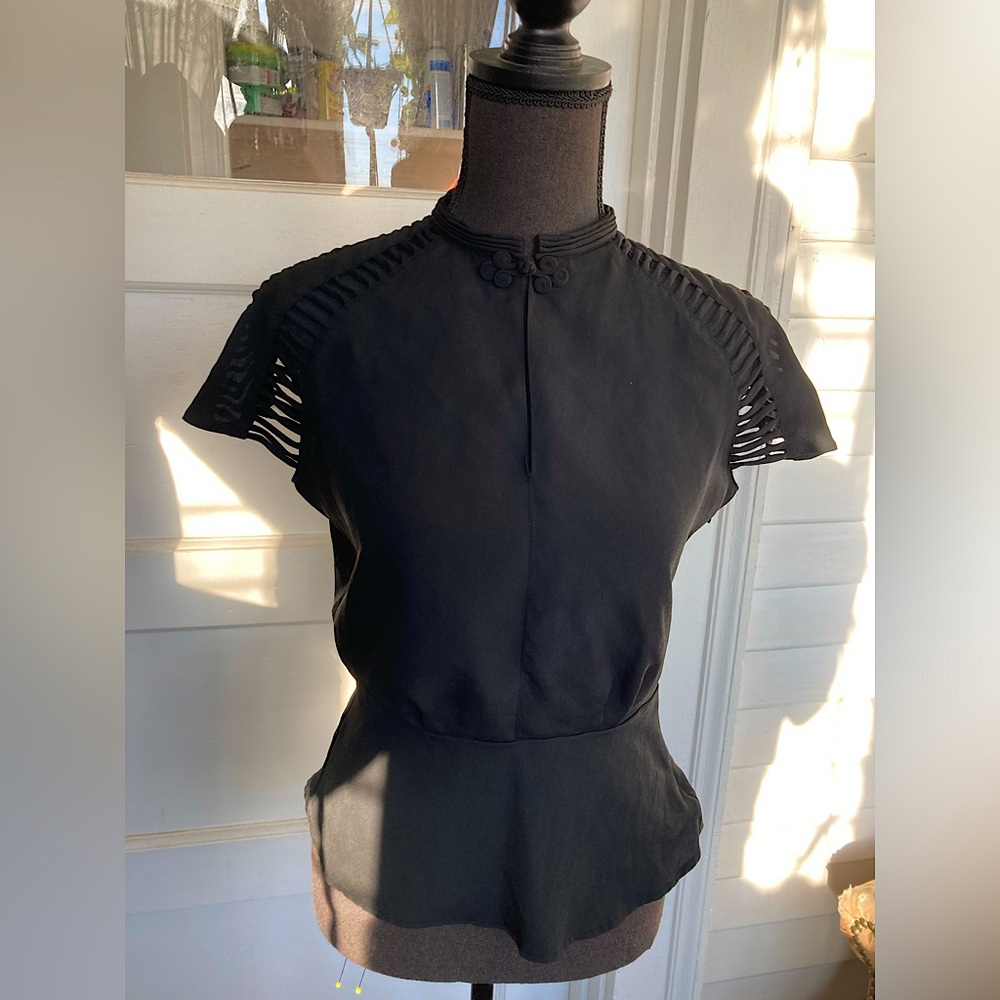 Asian inspired keyhole top with cutout cap sleeves, mandarin collar and peplum